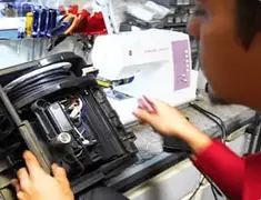 Vacuum repair technician servicing internal components on a workbench in Colorado Springs, CO