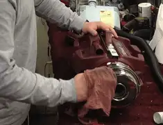 Vacuum repair technician cleaning and servicing a vacuum motor in Colorado Springs, CO